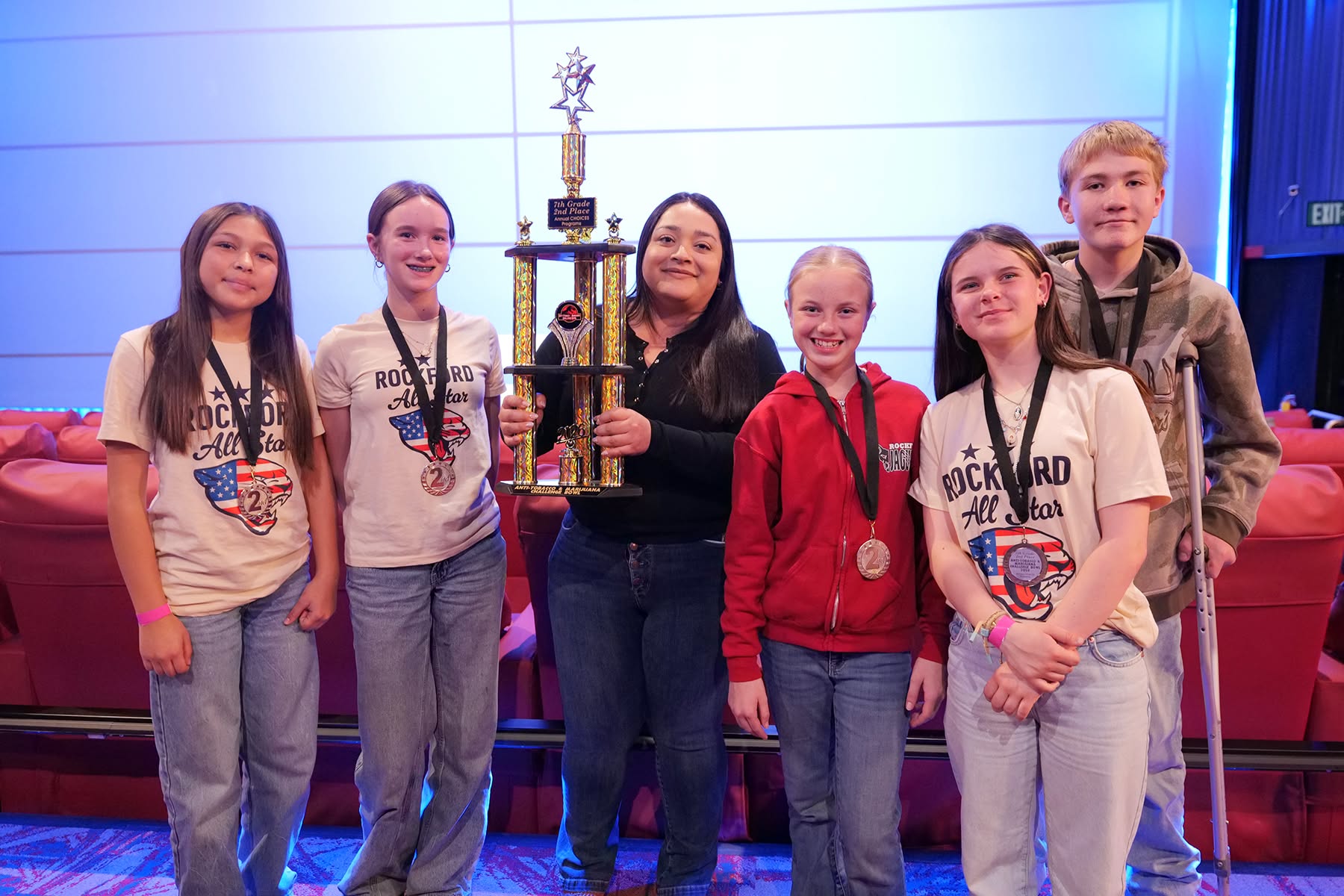 Students and teacher with trophy.