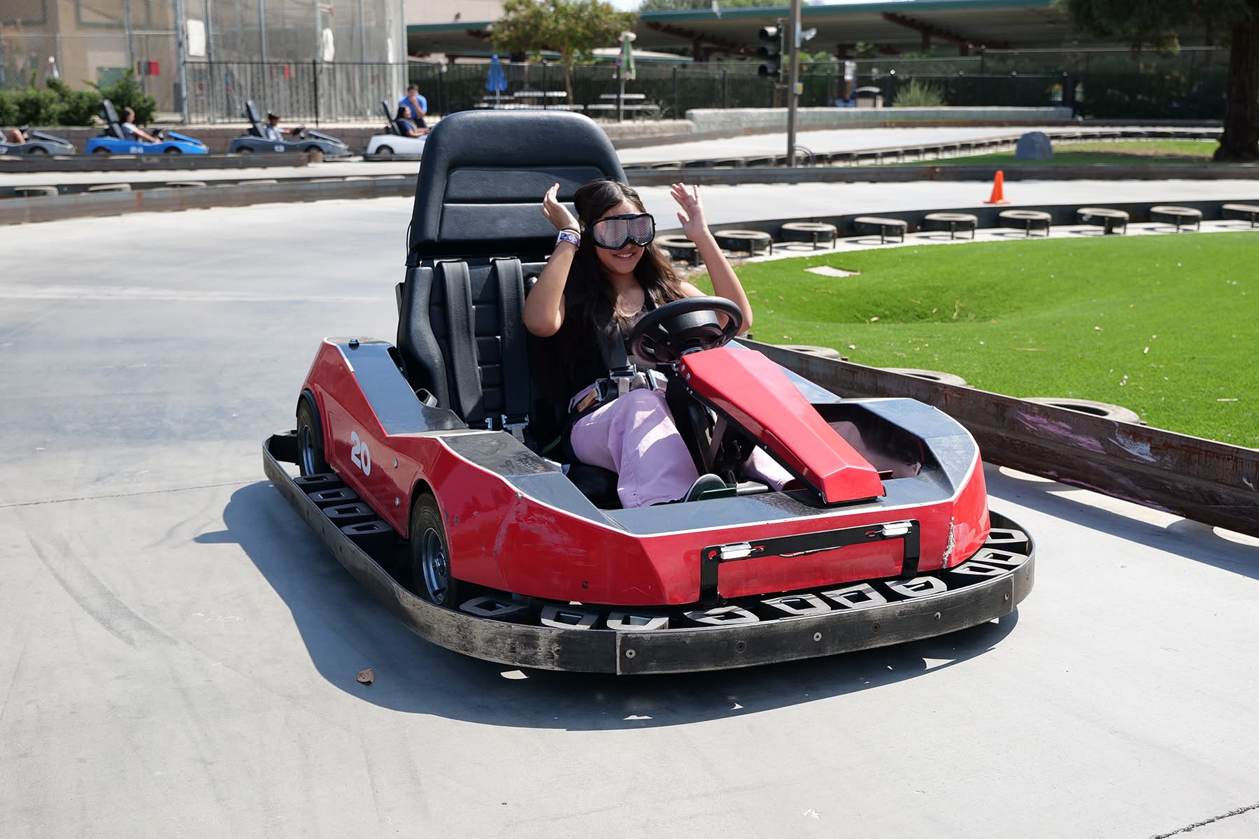 Student with cannabis goggles driving a go kart.