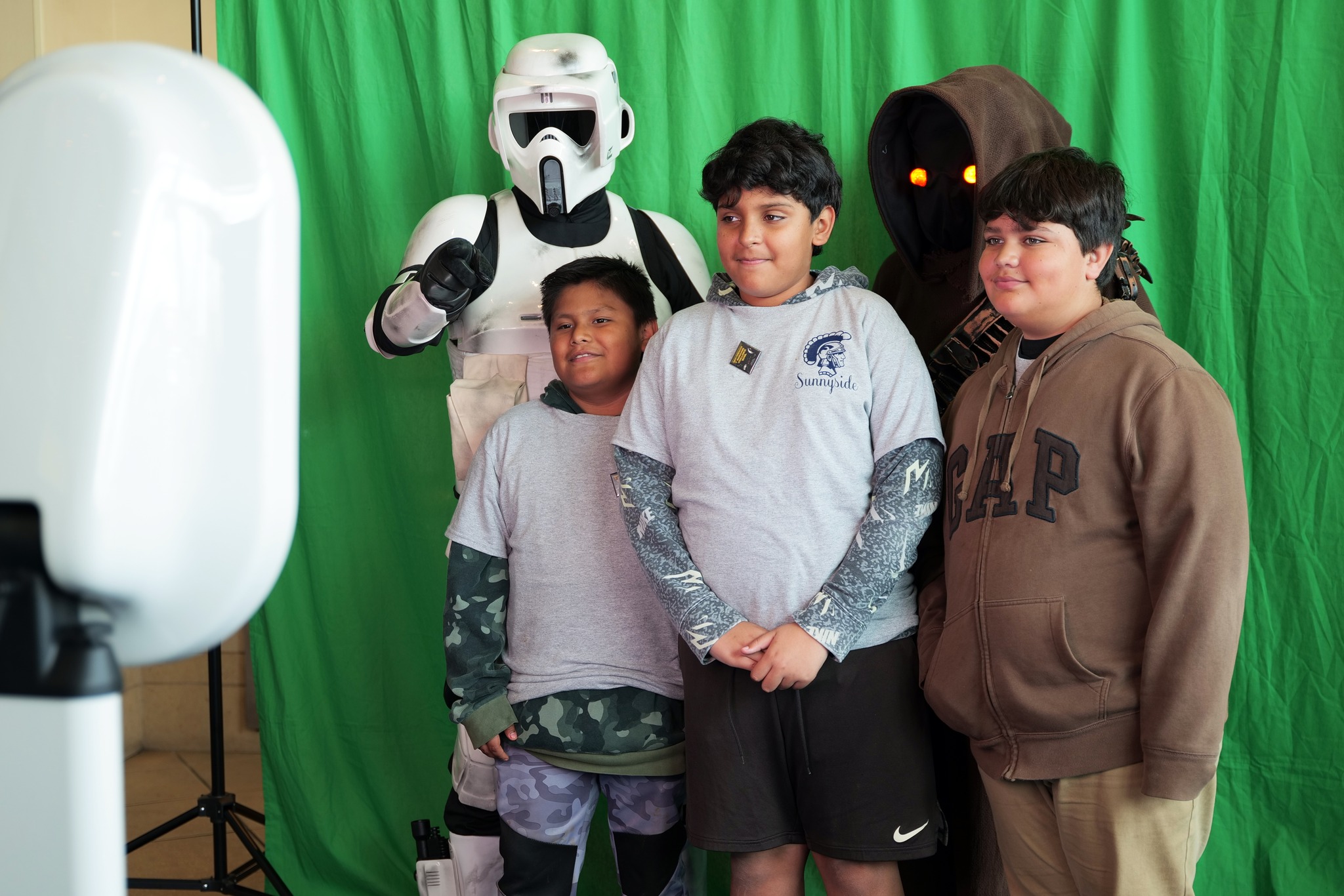 students taking a photo with star wars characters in a photo booth