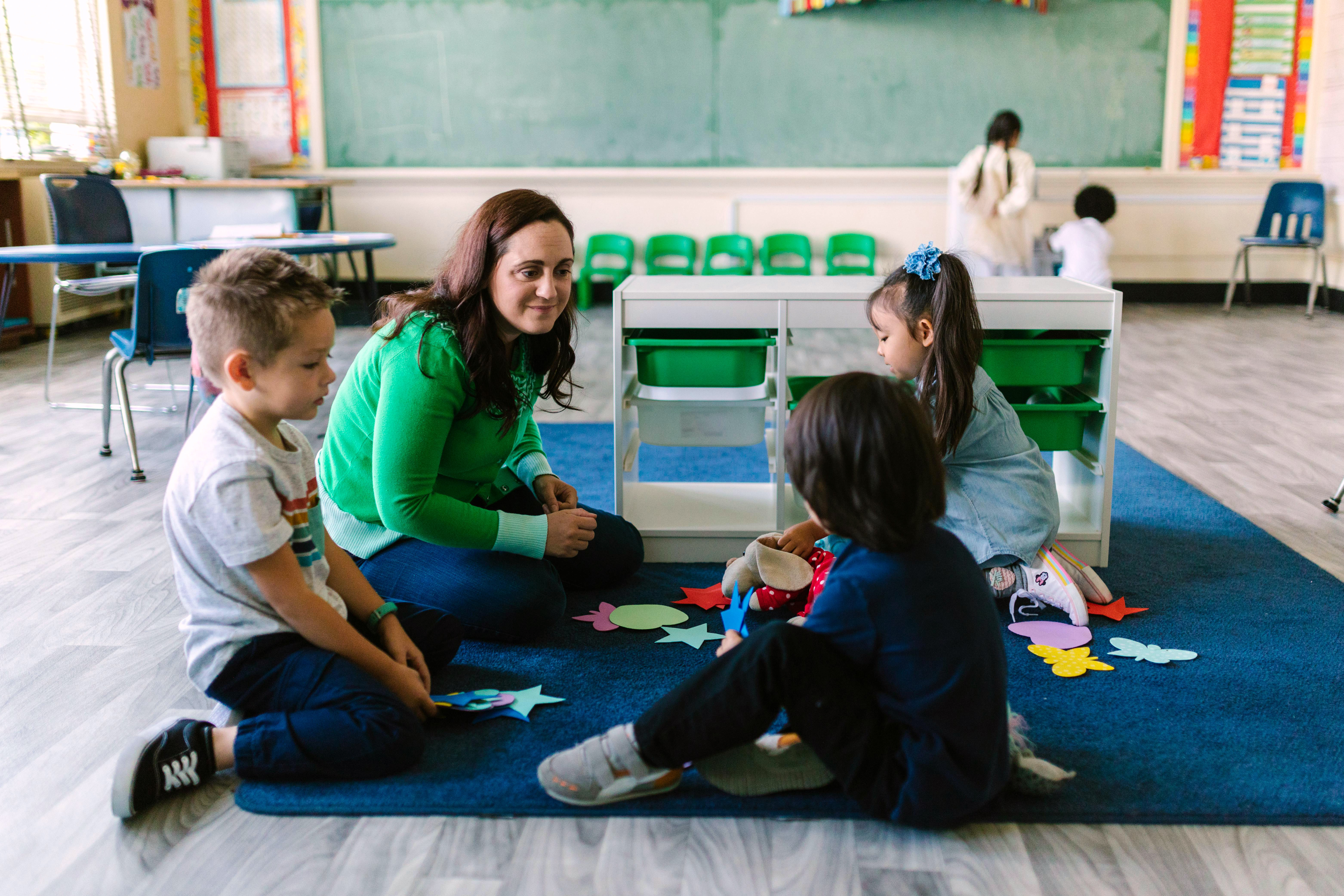 teacher on mat with students
