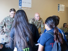 Army recruiters talking to students