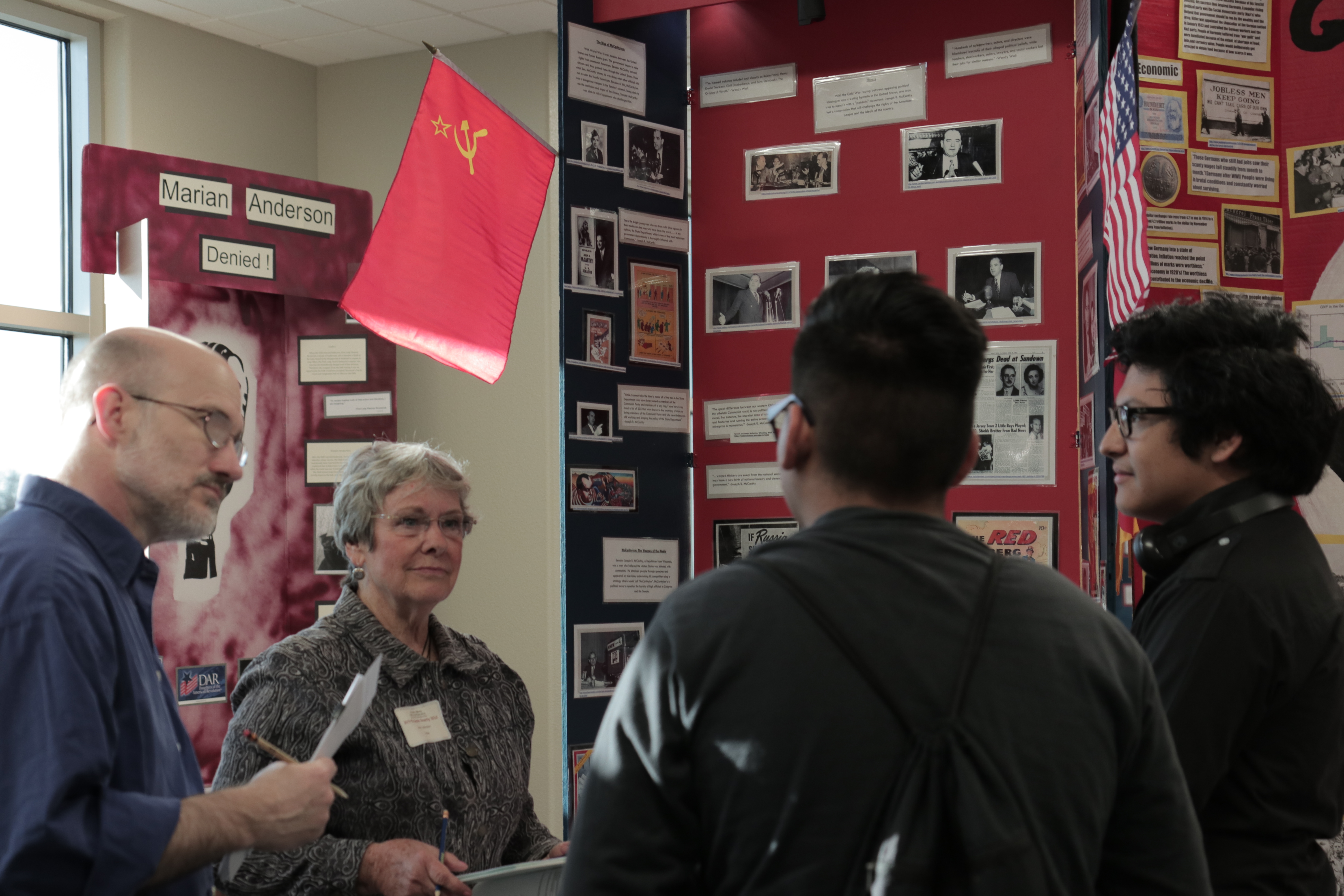 National History Day Tulare County judges interviewing high school students at their exhibit