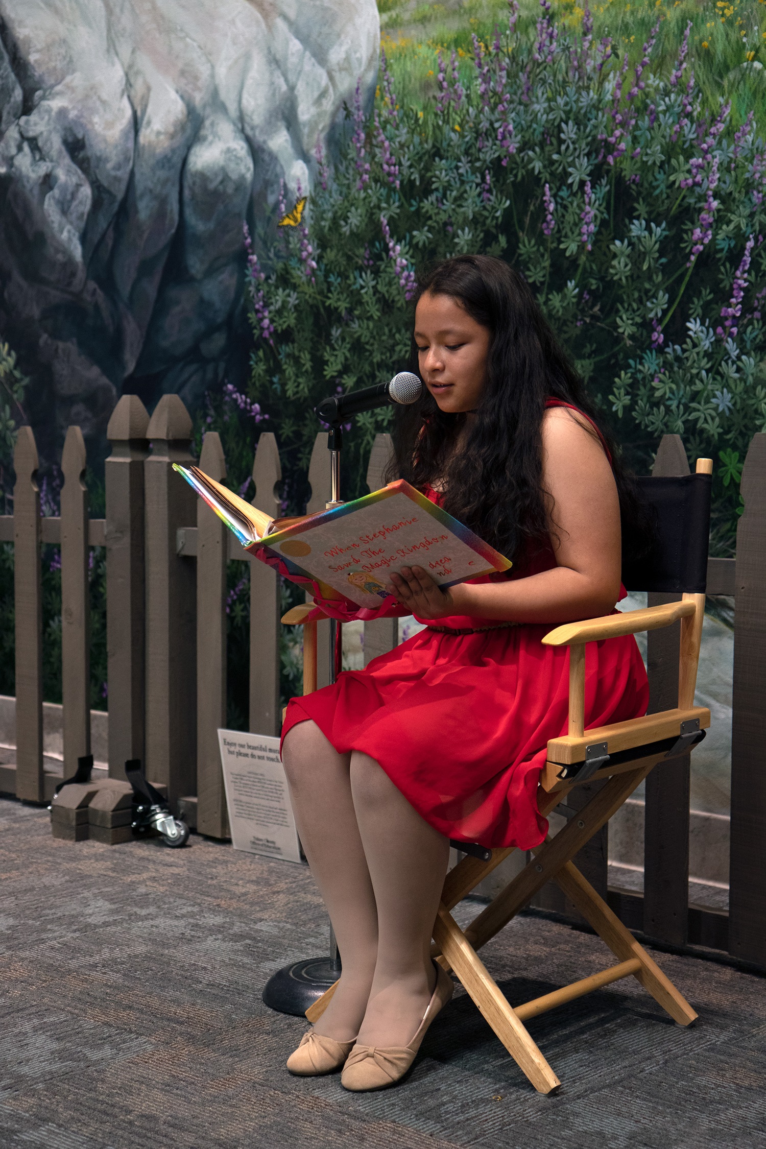 Student reading book aloud at Young Authors Faire