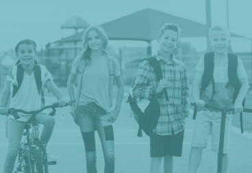 FYS 4 student smiling with backpacks on.