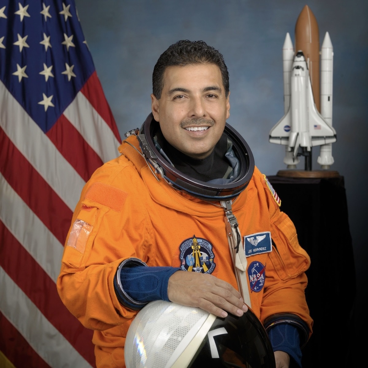 male speaker orange astronaut