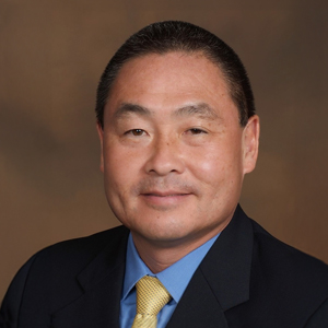 Man in suit with yellow tie smiling